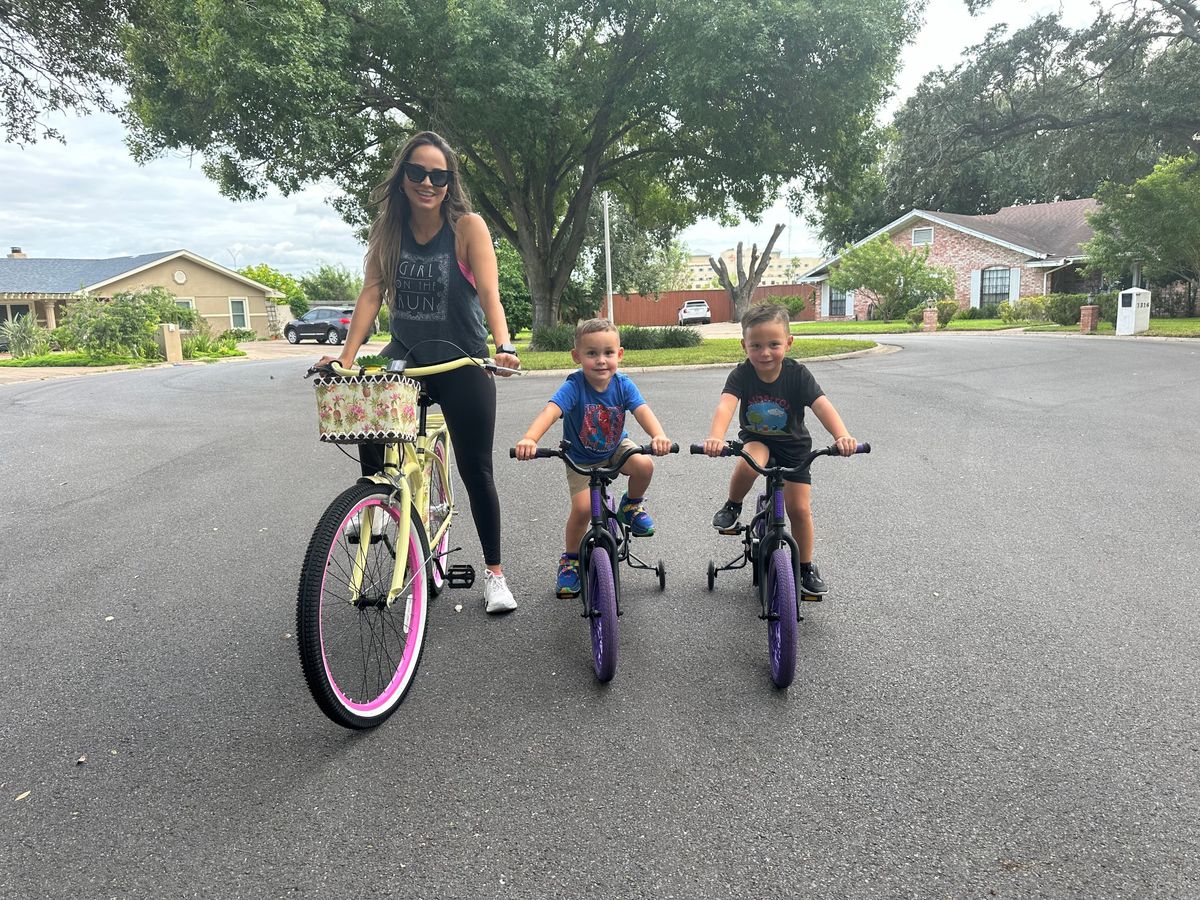 Tatiana riding bikes with Santiago and Marcelo in the neighborhood