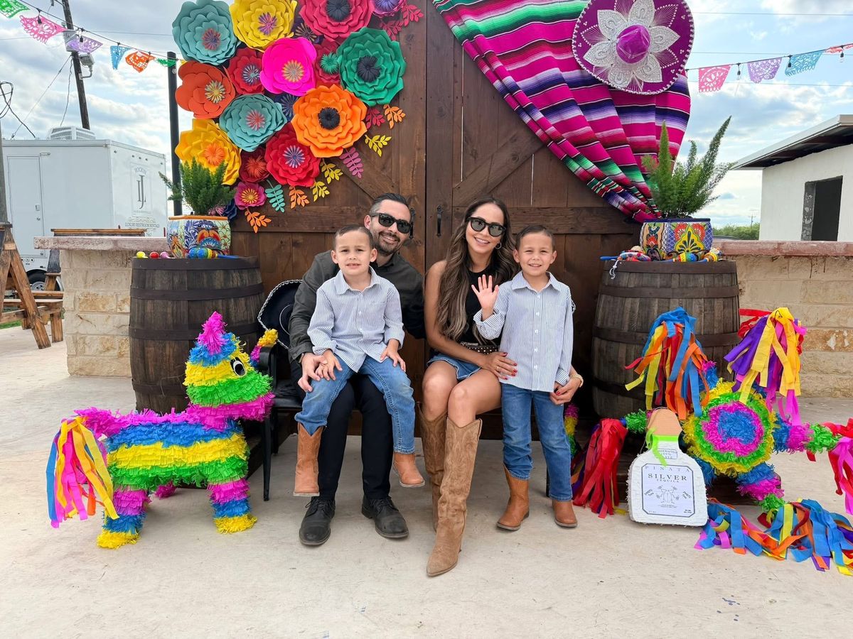 Mark, Tatiana, Santiago and Marcelo smiling at a festive outdoor celebration